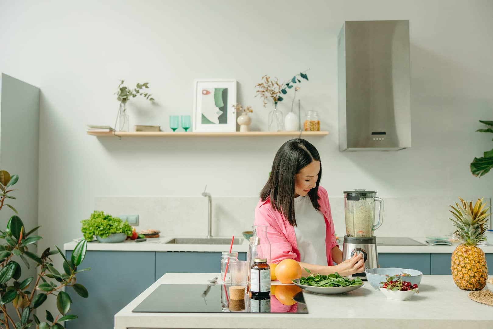 Woman making a healthy smoothie in her kitchen